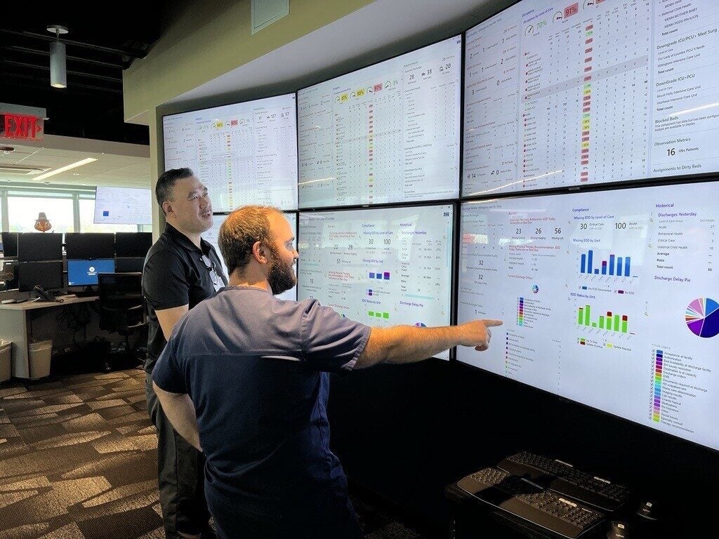 Dos trabajadores miran la pantalla.